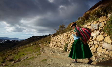 A woman with load on her back, Isla del Sol, Lake Titicaca, Bolivia.