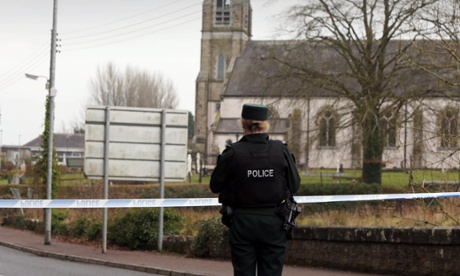 A police officer at St Mary’s church in Newtownbutler after the shootings on Wednesday.