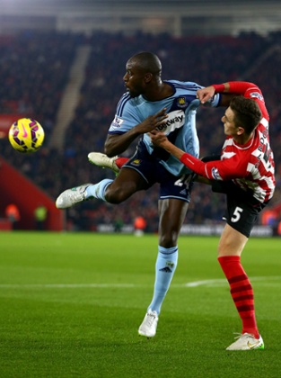Carlton Cole of West Ham battles for the ball with Florin Gardos of Southampton.