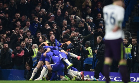 Chelsea fans celebrate as the Chelsea players leap onto goalscorer Willian.