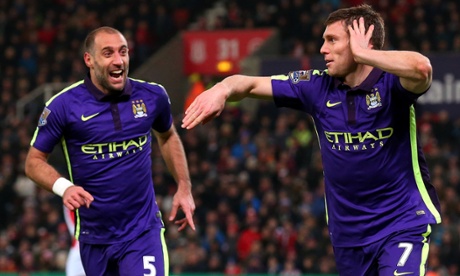 James Milner celebrates scoring Manchester City's second goal against Stoke with his team-mate Pablo Zabaleta.