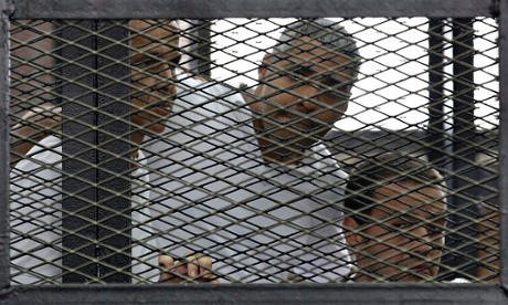 Al-Jazeera's Peter Greste, Mohamed Fahmy and Baher Mohamed listen to the ruling as they are jailed