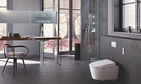 A grey painted bathroom with big back windows, a shower and geberit toilet