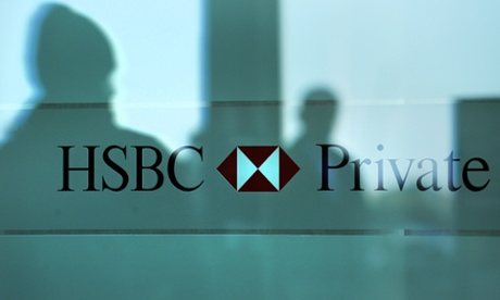 Silhouettes of passersby are reflected on the wall of a branch of HSBC Private Bank (Suisse) SA on December 9, 2009 in the center of  Geneva.
