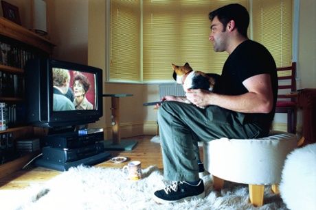 Andrew Collins and friend watching EastEnders in 2000, around the time he became a scriptwriter for the show.