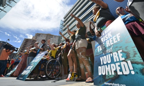 Demonstrators outside the headquarters of Commonwealth Bank in Sydney to protest at plans  for coal port coal expansion on the Great Barrier Reef as part of Global Divestment Day.