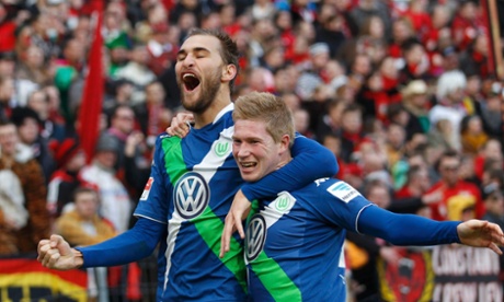 Wolfsburg's Bas Dost celebrates with teammate Kevin De Bruyne after scoring the opener.