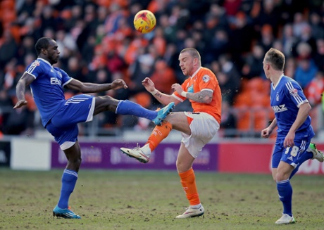 Jamie O'Hara of Blackpool and Forest's Michail Antonio battle on the Bloomfield Road pitch.