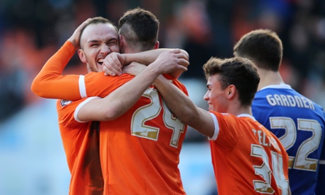 Blackpool's Gary Madine celebrates with Tom Aldred after the first of eight goals at Bloomfield Road; the match against Forest ended 4-4.