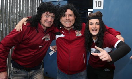 Northampton Town fans wear long hair wigs and headbands in homage to John-Joe O'Toole  toprior the Sky Bet League Two match between Mansfield Town and Northampton Town at One Call Stadium on February 14, 2015 in Mansfield, England.  (Photo by Pete Norton/Getty Images)FootballSoccerClub Soccer