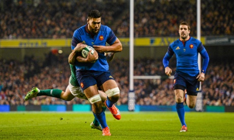 Romain Taofifenua breaks through the tackle of Ireland's Rob Kearney to score.