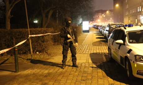 An armed policeman on guard at the site of the attack.
