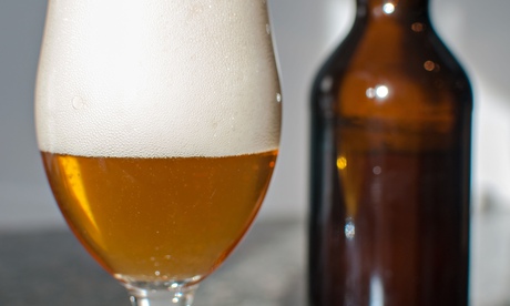 A craft beer bottle and glass