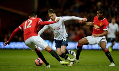 Preston North End's Joe Garner takes on Luis Antonio Valencia and Chris Smalling.