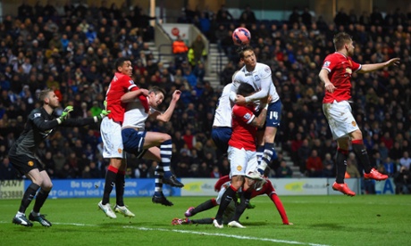 Joe Garner climbs above Marcos Rojo to head the ball over.