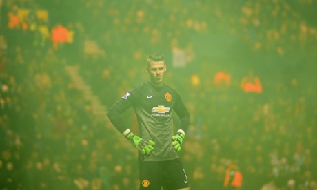 David De Gea looks on through smoke from a flare; he should have done better with Laird's goal.