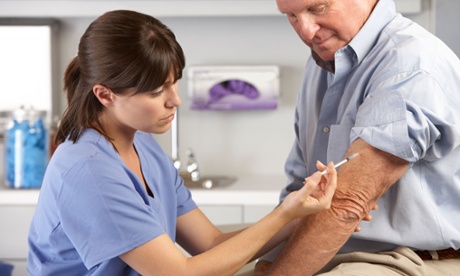 Nurse administers flu jab to older man