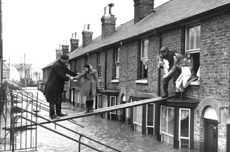 A family escape their flooded home in Whitstable, Kent, in February 1953.