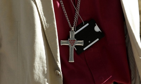 A member of the clergy. The letter says: 'We are not made in isolation. We belong together in a creation.'