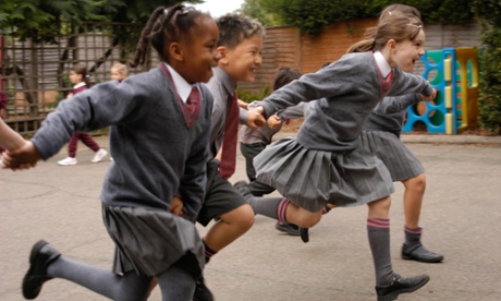 Pupils in a school playground. The letter says that schools should try to ‘model a community of communities’.