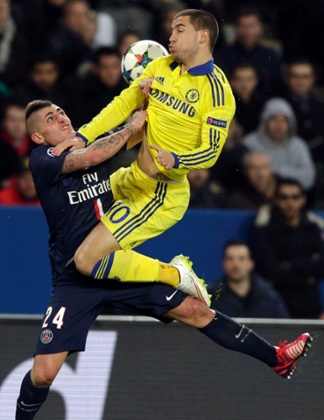 Paris St Germain's Marco Verratti challenges Chelsea's Eden Hazard.