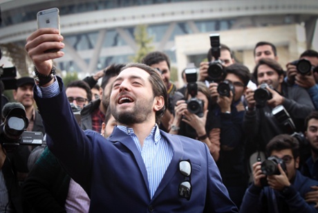 Iranian actor Bahram Radan takes selfie during the photocall for the film 'Ice Age' at the 33rd Fajr film festival in Tehran.