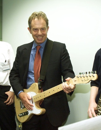 British Prime Minister Tony Blair (L) plays the guitar with pupil Andrew Cragg, 15, on saxaphone, during the visit of the PM to the  1.2 million City Learning at Dyke House School in Hartlepool Friday September 7 2001. See PA story POLITICS Blair. PA Photo: Owen Humphreys    POOL