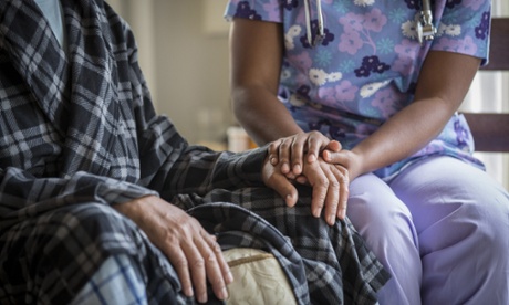 Carer holds man's hand