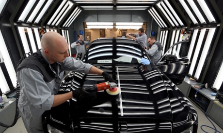 Worker polish a new Rolls-Royce Ghost at the company's factory in Goodwood