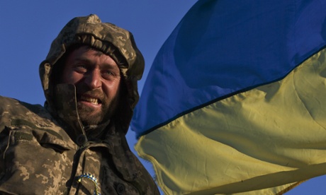 An Ukrainian soldier rides on an armoured vehicle during the retreat from Debaltseve, which has fallen to Russia-backed separatists after weeks of relentless fighting.