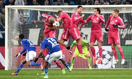 The Real Madrid wall does it's job and blocks Dennis Aogo's free-kick.