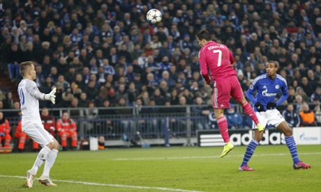 Real Madrid's Cristiano Ronaldo scores the opening goal past Schalke's goalkeeper Timon Wellenreuther.