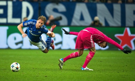 Schalke's Benedikt Hoewedes is taken down by Toni Kroos and the Real player goes into the ref's book