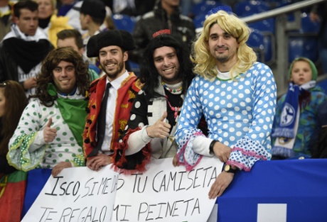Best dressed fans at the Schalke 04 vs Real Madrid match.  Their banner reads Dressed up fans hold a banner reading 