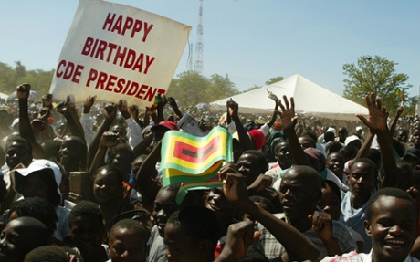 Supporters of Zimbabwe’s president, Robert Mugabe, cheer at a huge 84th birthday rally in 2008.