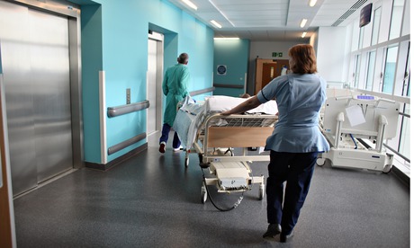 Nurses moving a hospital patient