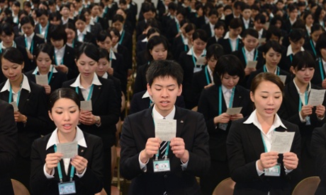 Room full of workers singing company song at a firm in Tokyo in 2013.