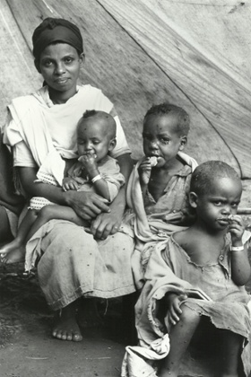 Children eating the Oxfam Energy Biscuit, of which Dr Tim Lusty led the development and field testing.
