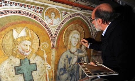 Italian restorer Sergio Fusetti looks at frescoes during an inspection of the vault of the Chapel of Saint Nicolas in the lower Basilica of San Francis in Assisi.