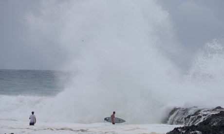 Surfers head out at Snapper Rocks as cyclone Marcia approaches the coast of Queensland. Photograph: Chris Hyde/Getty Images