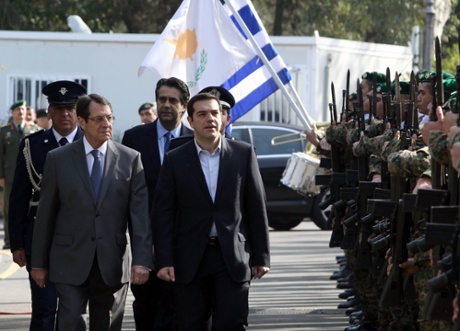 President of Cyprus Nikos Anastasiadis (L) and the new Greek Prime Minister Alexis Tsipras (C) inspect a presidential honor guard during the welcoming for Tsipras at the Presidential Palace, Nicosia, Cyprus, 02 February 2015.
