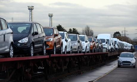 Cars are loaded onto a freight train at a Ford factory in Dagenham, Essex.