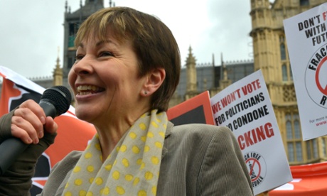 Caroline Lucas, microphone in hand, at a rally in London