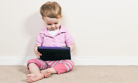 Baby girl plays with ipad.
