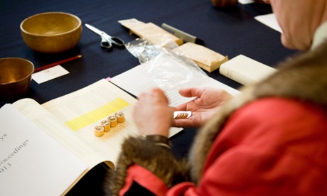 A jury member chooses a coin to examine at the Trial of the Pyx.