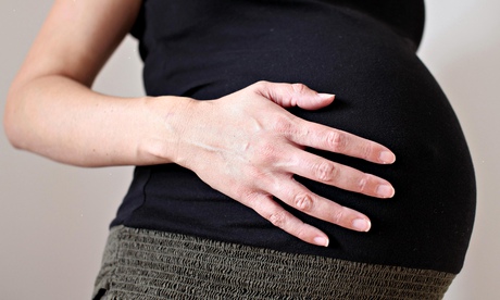 Pregnant woman holding her stomach