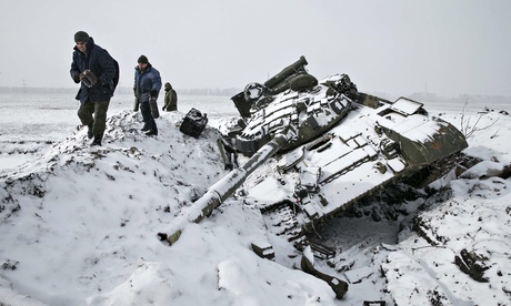 Members of the separatist self-proclaimed Donetsk People's Republic army collect parts of a destroye