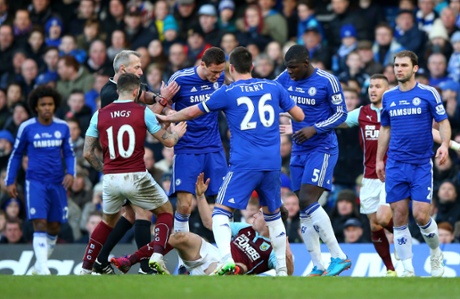 Referee Martin Atkinson shows the red card to Nemanja Matic of Chelsea for his reaction to the tackle by Ashley Barnes.