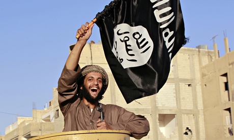 An Islamic State fighter waves the Isis flag in Raqqa, Syria