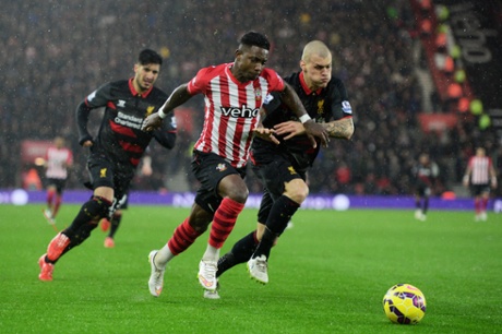 Elijero Elia is challenged by Martin Skrtel.